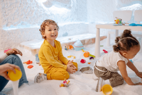 a group of children playing in a play room